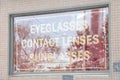 eyeglasses contact lenses sunglasses sign white red inside window writing text 83 p 20
