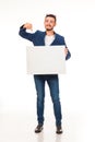 A guy with a beard posing with a white sign. Can be used for advertising, logo and business cards, contact phones, shares, etc.