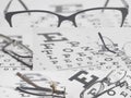 Eyeglasses on eyesight test chart background collage Royalty Free Stock Photo