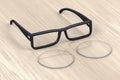 Eyeglasses frame and lens on wood table