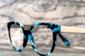 Eyeglasses Glasses with Bifocals and Black Blue Frame Fashion Vintage Style on Wood Desk Background, Rustic Still Life Style