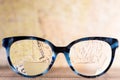 Eyeglasses Glasses with Bifocals and Black blue Frame smudged agaist written letters. Blurry Vision Concept