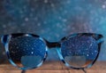 Eyeglasses Glasses with Bifocals and Black blue Frame smudged view agaist a starry night sky. Blurry Vision Concept