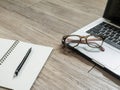 Eyeglasses on laptop computer and a black pencil on a notebook Royalty Free Stock Photo