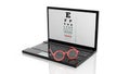 Eyeglasses on laptops keyboard with eyesight test on screen Royalty Free Stock Photo
