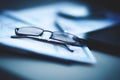 Eyeglasses lie on the documents and charts, next to the Tablet PC Royalty Free Stock Photo