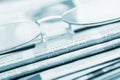 Eyeglasses lie on a pile of newspapers.Blue toned Royalty Free Stock Photo