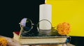 Eyeglasses on old books. Glasses on stack of books on black and yellow background surrounded by decor.