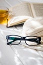 Eyeglasses, open book, Cup of tea and Knitting threads Royalty Free Stock Photo