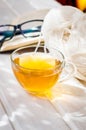 Eyeglasses, open book, Cup of tea and Knitting threads Royalty Free Stock Photo