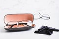 Eyeglasses in an open hard case and a cleaning cloth in front of other glasses on a table Royalty Free Stock Photo