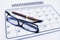 Eyeglasses and Pen on Calendar Royalty Free Stock Photo