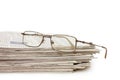 Eyeglasses on a pile of newspapers Royalty Free Stock Photo