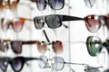 Eyeglasses on the showcase of optical store. Sale of fashion eyewear and fashionable eyeglass frames. Service of selection of