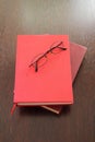 Eyeglasses and two red books Royalty Free Stock Photo