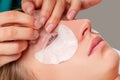 Eyelash care treatment procedures. Woman doing eyelashes lamination, staining, curling, laminating and extension for lashes