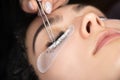 Eyelash extension procedure. Beautiful woman with long eyelashes in a beauty salon. Lashes Royalty Free Stock Photo