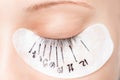 Eyelash extension procedure. Master marker puts markup scheme guide lashes