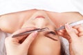 Eyelash Extension Procedure. Woman Eye with Long Eyelashes. Eyelashes with rhinestone. Lashes, close up, macro Royalty Free Stock Photo