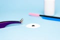 Eyelash extension tweezers, glue, blue background. Tools for the lashmaker