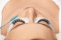 Eyelashes extensions. Fake eyelashes. Eyelash extension procedure.Close up portrait of woman eye with long eyelashes Royalty Free Stock Photo