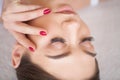 Eyelashes extensions. Fake Eyelashes. Eyelash Extension Procedure. Professional stylist lengthening female lashes Royalty Free Stock Photo