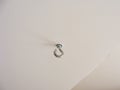 Eyelet-screw to fix things at a wall or ceiling, hook on the ceiling Royalty Free Stock Photo