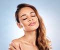 Eyes closed, skincare and woman with beauty or cosmetics in studio on blue background or relax with calm model. Face
