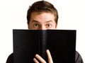 Eyes of surprised man above book Royalty Free Stock Photo