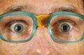 Eyes of surprised person in old spectacles Royalty Free Stock Photo