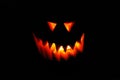eyes and teeth glowing fiery Jack-o`-lantern face from a pumpkin on a halloween