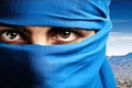 The eyes of a woman in a blue niqab. Ramadan as a time of fasting and prayer for Muslims