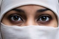 The eyes of a woman in a white niqab. Ramadan as a time of fasting and prayer for Muslims