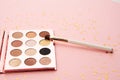 Eyeshadow makeup brushes collection professional cosmetics accessories on pink background