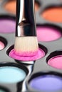 Eyeshadow set with makeup brush picking up color Royalty Free Stock Photo