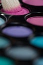 Eyeshadow set with makeup brush picking up color Royalty Free Stock Photo