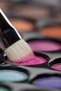 Eyeshadow set with makeup brush picking up color Royalty Free Stock Photo