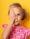 Eyesight check. girl covering one eye with hand. ophthalmology concept. Royalty Free Stock Photo