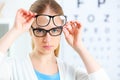 Eyesight check. woman choose glasses at doctor ophthalmologist o