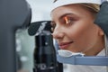 Eyesight Exam. Woman Checking Eye Vision On Optometry Equipment