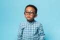 Eyesight. Portrait of black little boy wearing eyeglasses and looking carefully, posing on blue studio background Royalty Free Stock Photo