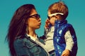 Eyewear concept. Portrait of fashionable baby boy & his gorgeous mother hollywood star in trendy sunglasses walking in the Royalty Free Stock Photo