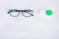 Eyewear to improve vision and contact lens storage containers, on a light background Royalty Free Stock Photo