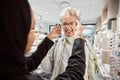 Eyewear, vision and optometry with a senior woman in an optician office for prescription lenses. Glasses, eyesight and