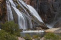 Ezaro Waterfall surrounded by rocks and greenery in Galacia in Spain Royalty Free Stock Photo