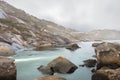 A river valley in Ezaro near the Atlantic. Many rocks are in the water.