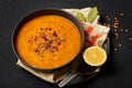 Ezogelin Soup in black bowl on dark slate table top. Turkish cuisine traditional dish with red lentils, bulgur and rice Royalty Free Stock Photo