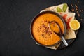 Ezogelin Soup in black bowl on dark slate table top. Turkish cuisine traditional dish with red lentils, bulgur and rice Royalty Free Stock Photo