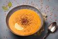 Ezogelin Soup in gray bowl on concrete table top. Turkish cuisine traditional dish with red lentils, bulgur and rice Royalty Free Stock Photo