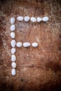 'F' alphabet made form white stone